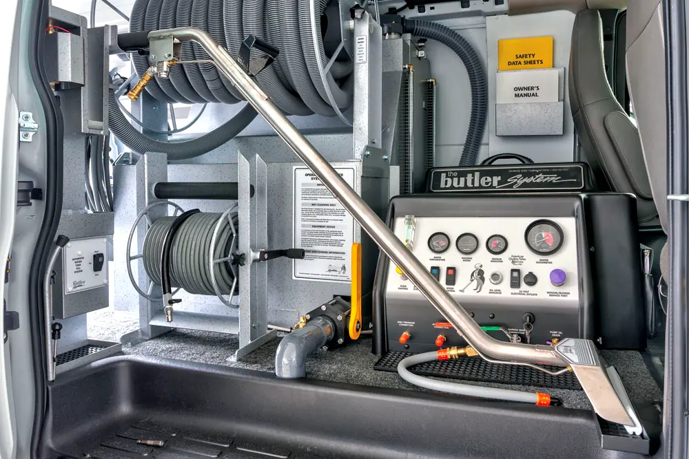 Butler truck-mounted cleaning system built into the Pure Surface Care van, showing the power unit, hose reels, and cleaning wand