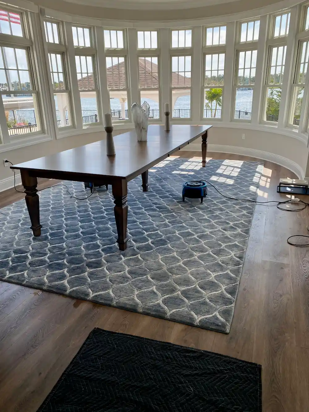 Dining room area rug drying with a fan after cleaning