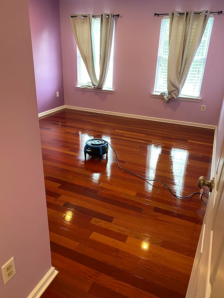 Bedroom hardwood floor drying with an air mover after a hardwood screen and recoat in a Monmouth County, NJ home