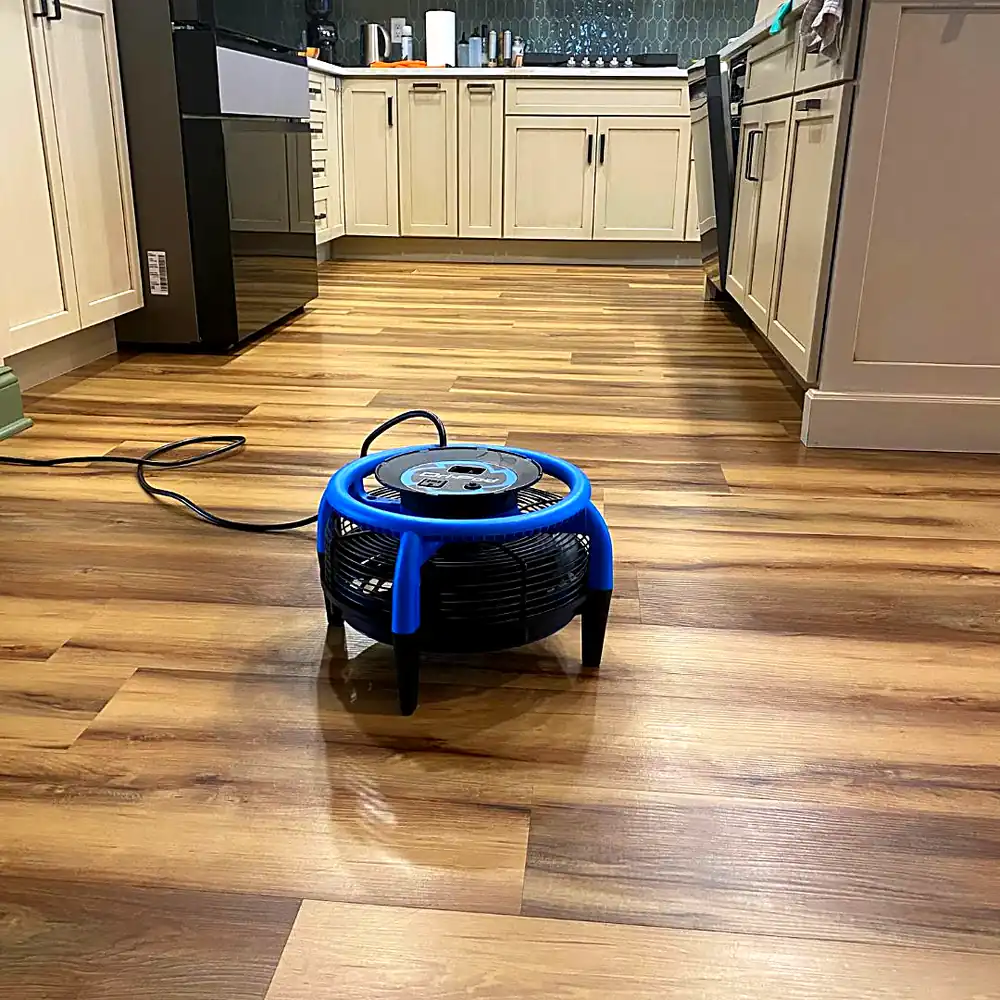 Air mover drying a wood-look vinyl plank kitchen floor after laminate and vinyl floor cleaning in a Monmouth County, NJ home