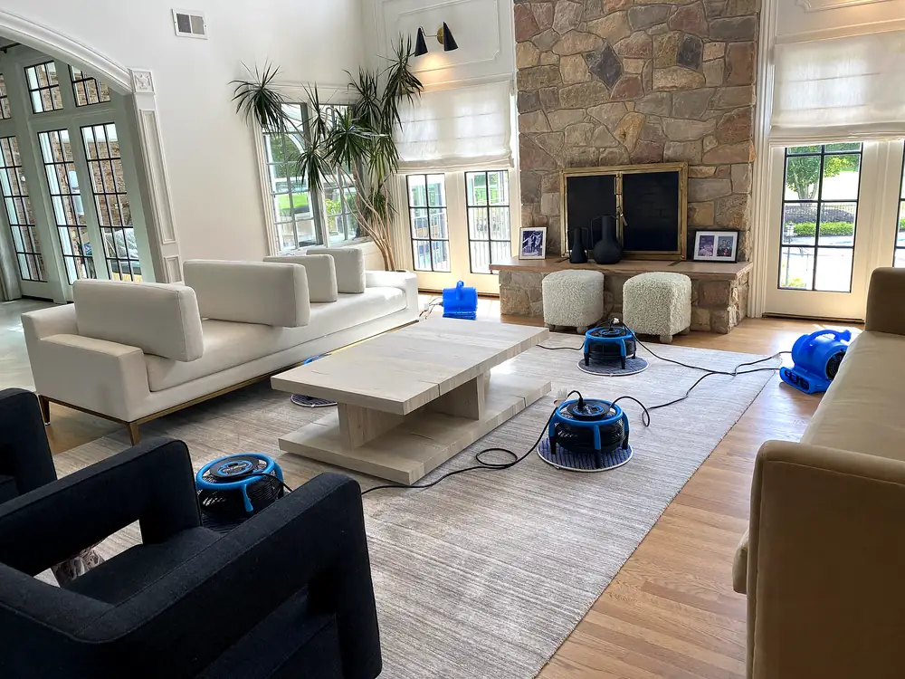 Living room sofas and armchairs drying with air movers after upholstery cleaning in a Monmouth County, NJ home