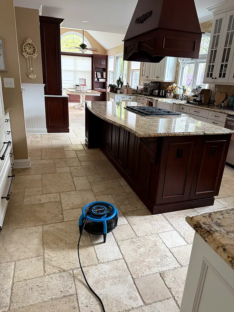 Travertine kitchen floor drying with a low-profile air mover after natural stone cleaning