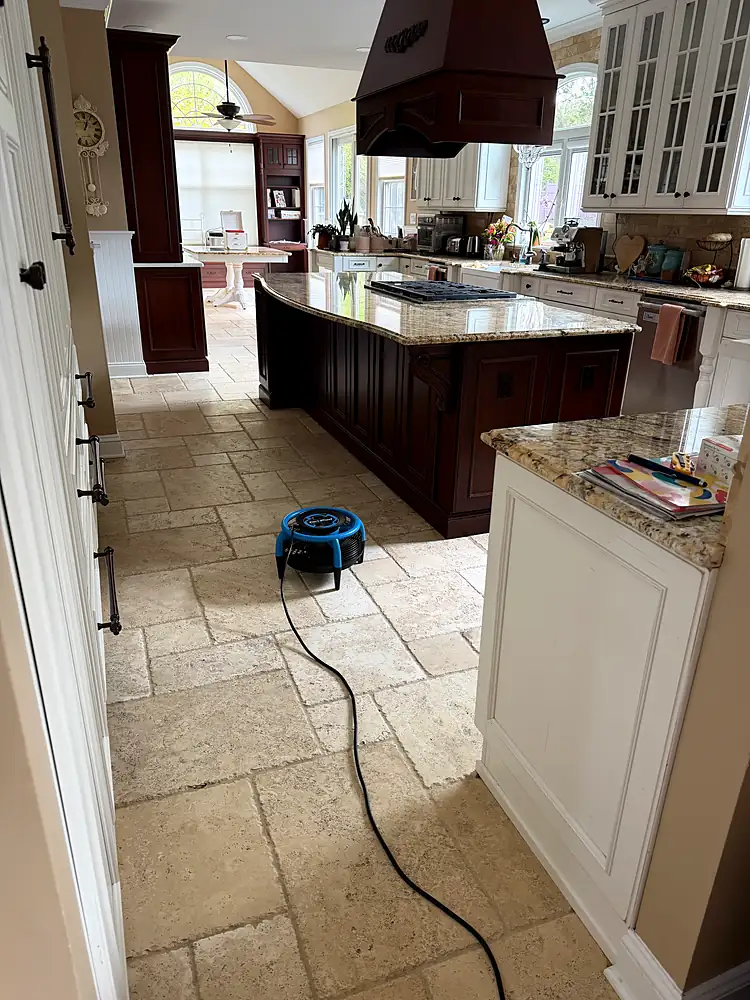 Travertine floor around a kitchen island drying after natural stone cleaning