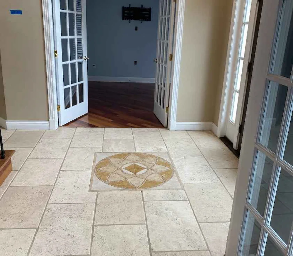 Travertine foyer with a stone medallion inlay after natural stone cleaning in a Monmouth County, NJ home