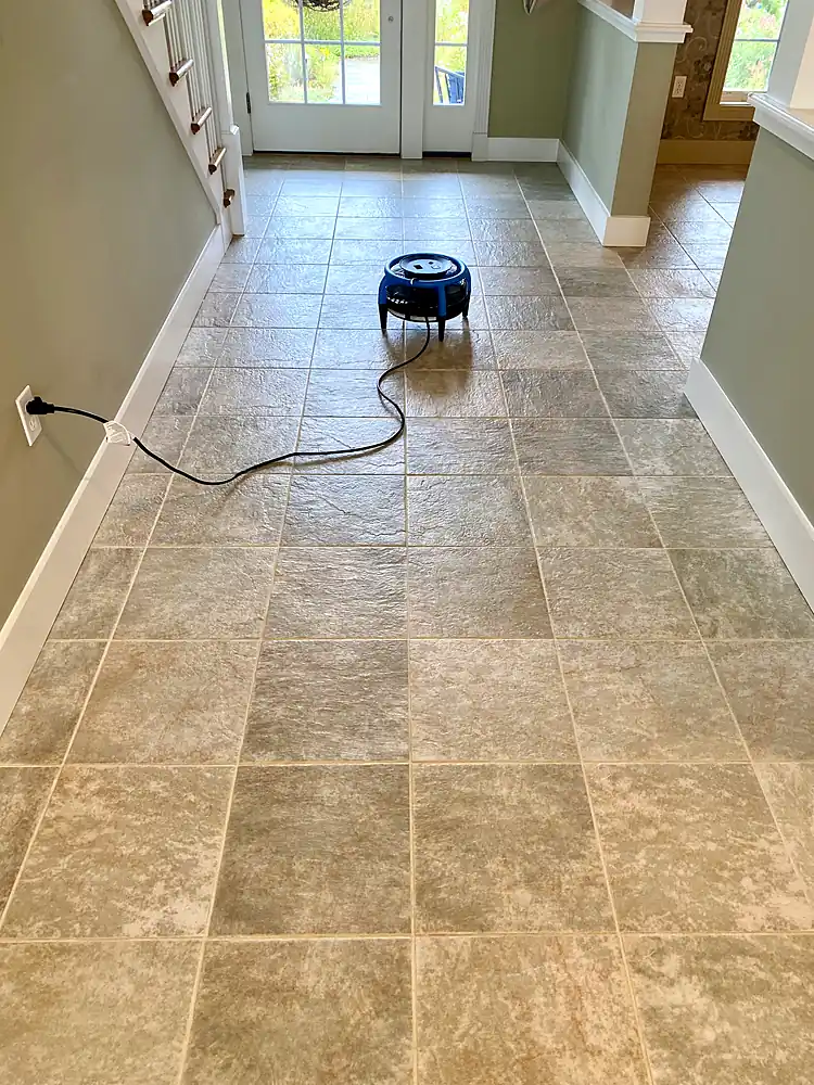 Beige tile hallway drying with an air mover after tile and grout cleaning