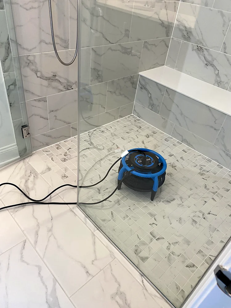 Marble shower and mosaic floor pan drying with an air mover after tile and grout cleaning