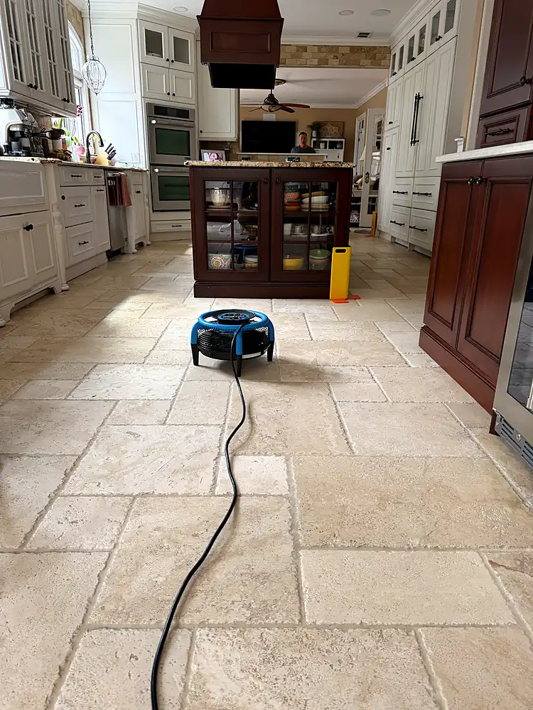 Travertine kitchen floor drying with an air mover after cleaning