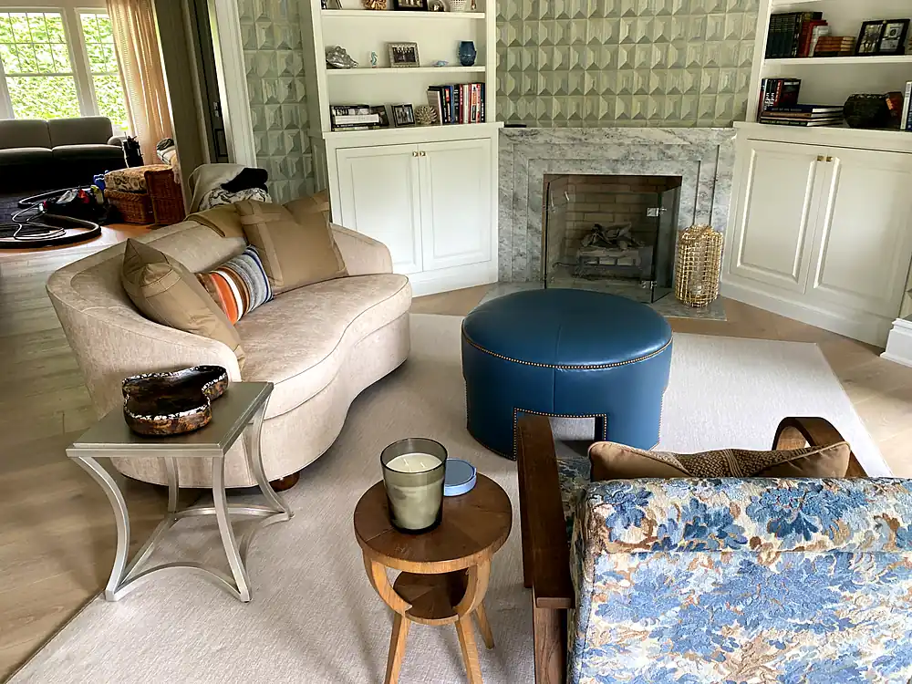 Curved sofa, leather ottoman, and floral armchair after upholstery cleaning in a Monmouth County, NJ living room